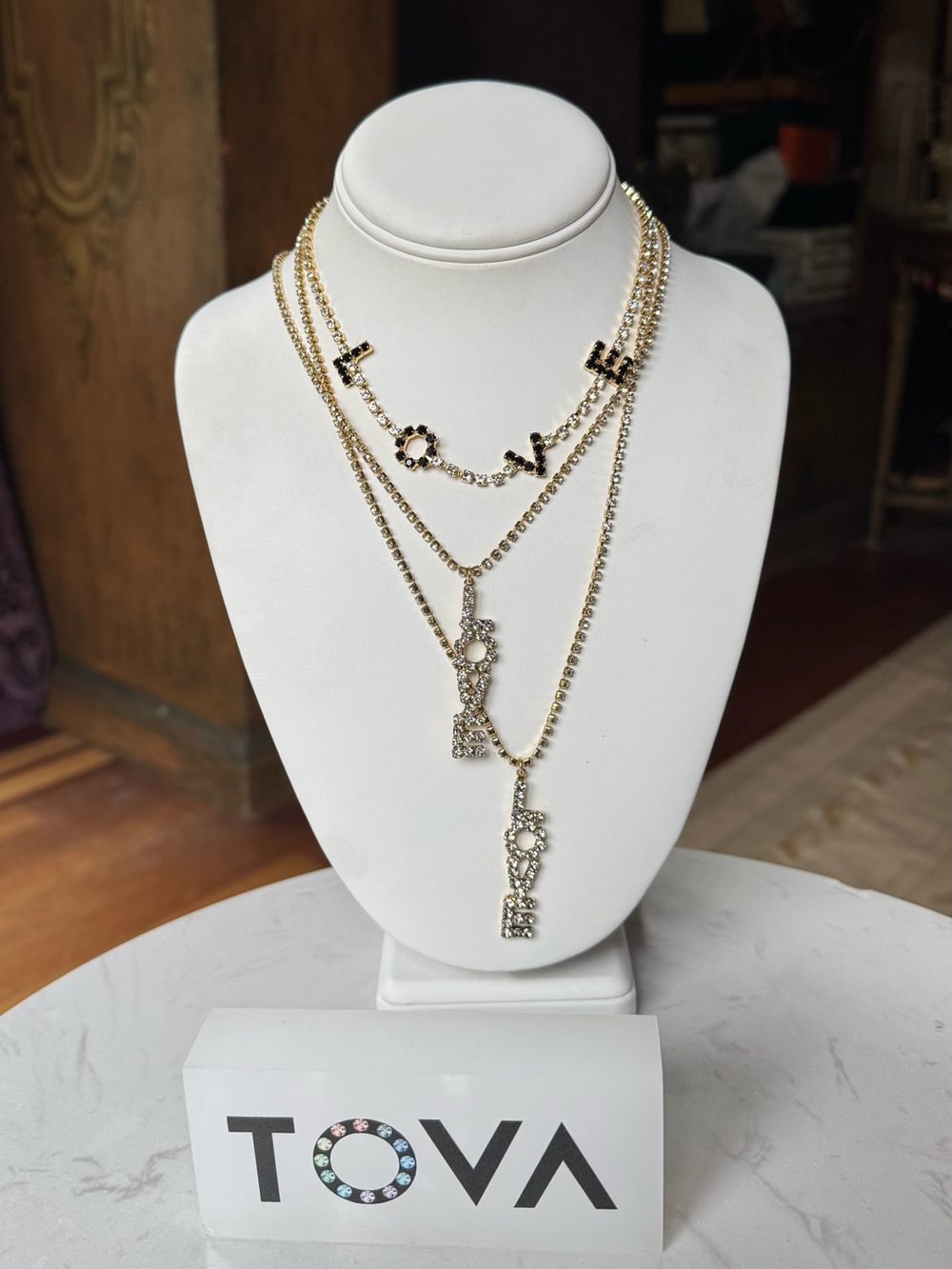 TOVA Gold Crystal 'LOVE' Pendant Necklace on a crystal chain